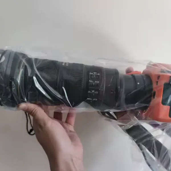 Transparent rain cover protecting a DSLR, verified buyer photo