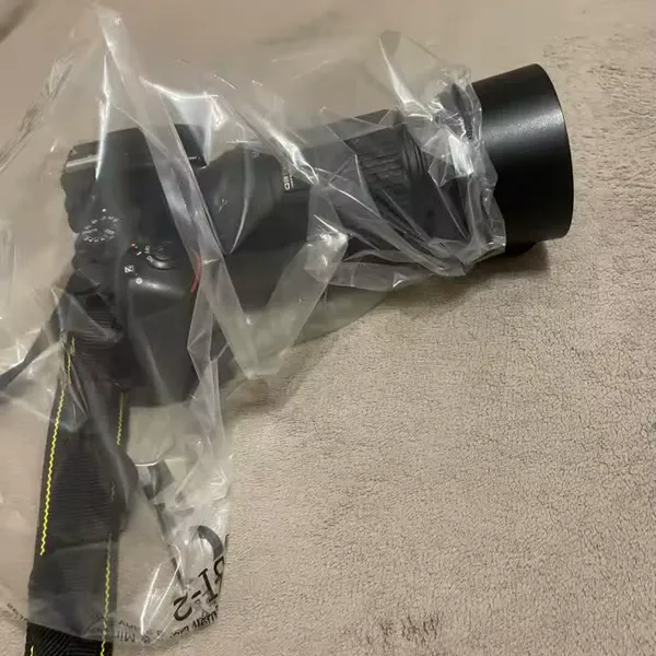 Rainskin clear camera rain cover on a real camera in the rain, photographed by Hana W., a verified buyer
